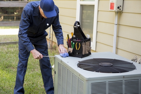 technician installing AC unit